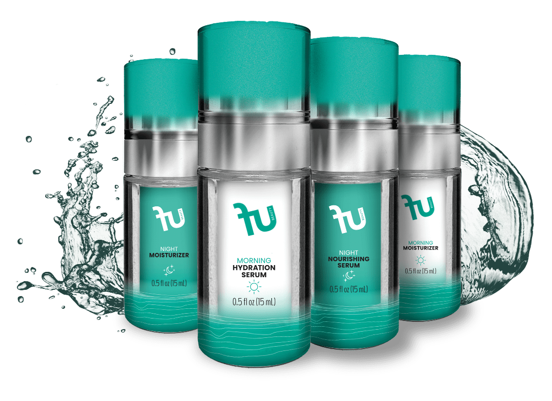 A photo shows four skincare product bottles with silver bases and teal caps, arranged in two rows. The front row, from left to right, features: "fu BEAUTY NIGHT MOISTURIZER" (moon and star icon), "fu BEAUTY MORNING HYDRATION SERUM" (sun icon), and "fu BEAUTY NIGHT NOURISHING SERUM" (moon and star icon). The back right bottle is "fu BEAUTY MORNING MOISTURIZER" (sun icon). Each bottle is labeled "0.5 fl oz (15 mL)". Water splashes are seen on both sides of the bottles.